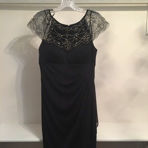 Formal navy dress with embellished sleeves.
